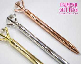 May include: Three diamond-shaped pens with personalized names, "Alexa", "Jackson", and "Amanda", in gold, silver, and rose gold finishes.  The pens feature a diamond-shaped top with a clear crystal.