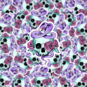 May include: A sticker featuring a teal skull decorated with pink roses and a purple cobra coiled around it. The background is a repeating pattern of similar skulls, roses, and snakes, creating a gothic and floral design.