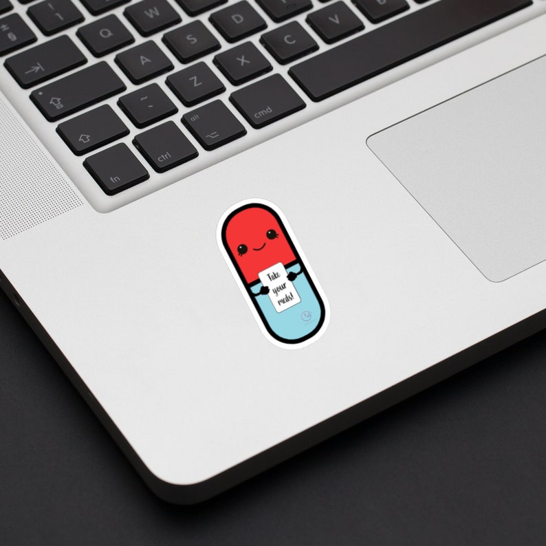 Picture shows the sticker described in the last image placed on a laptop to show size. The sticker sits to the left of the laptop track pad, a little smaller in height to the pad. It is about 2 keys in width.