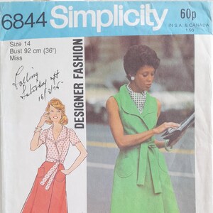 May include: Simplicity sewing pattern number 6844 for a sleeveless wrap dress with a collar. The pattern is for size 14, bust 92 cm (36 inches). The pattern shows a green dress with a white and black checkered scarf and a red dress with white polka dots.