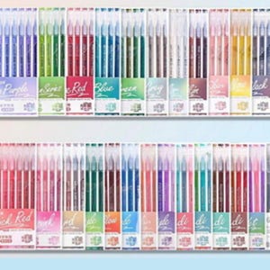 Può includere: Una collezione di penne gel in vari colori, disposte in file. Le penne sono in confezioni di plastica trasparente, con etichette che indicano la serie di colori, come "Grey Purple", "Red" e "Blue". L'immagine presenta una varietà di articoli di cancelleria.