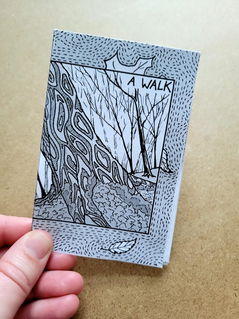 May include: A black and white illustration of a forest path with trees on either side. The title "A WALK" is written in black at the top of the image. The image is printed on a white background with a blue dotted border.