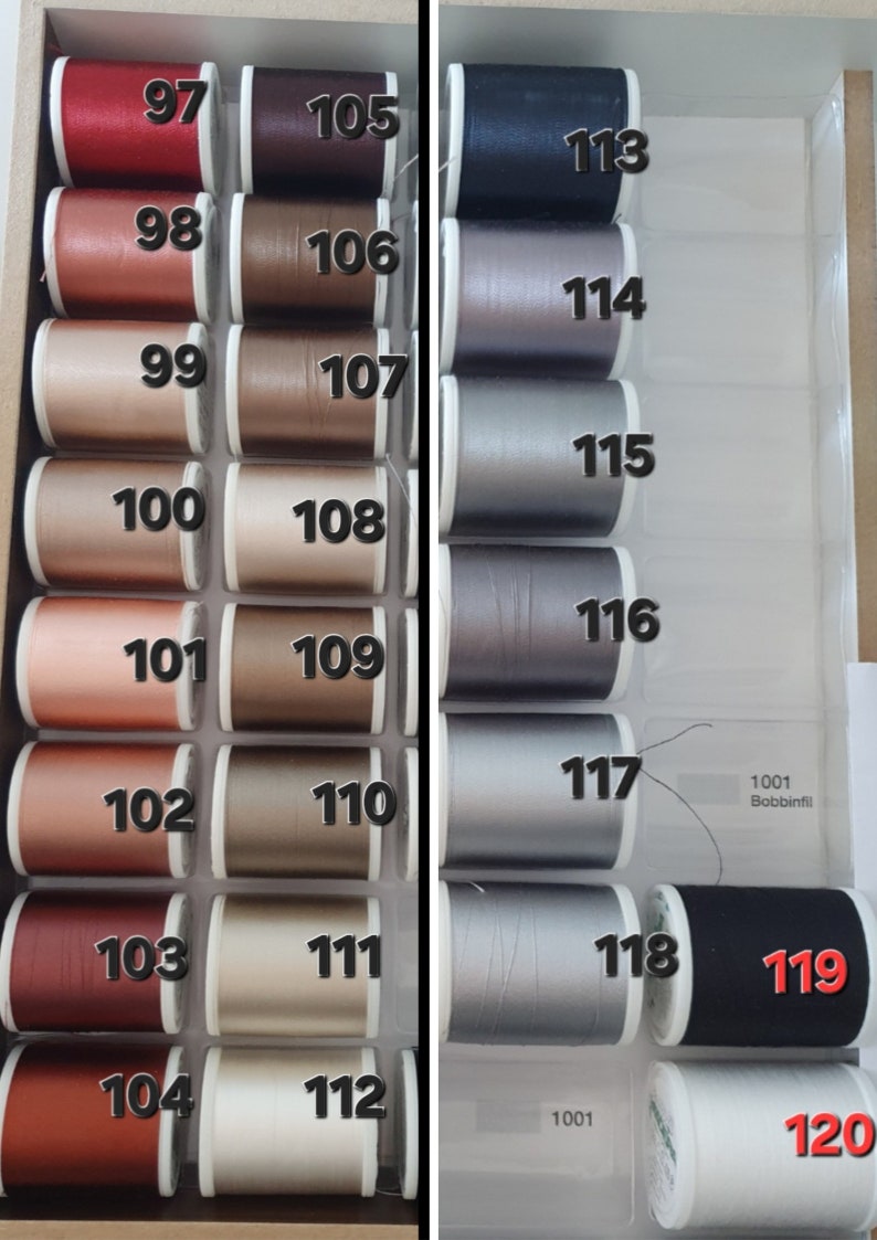 May include: A selection of sewing thread spools in various colors, arranged in a divided storage box. The spools are labeled with numbers from 97 to 120, with shades ranging from red and brown to silver and black. The text "1001 Bobbinfil" is also visible.