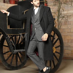 May include: A man wearing a black overcoat with a gray suit and black shoes. He is standing next to a black carriage.