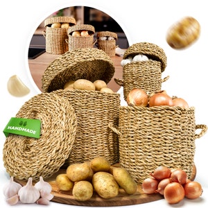 May include: Woven wicker baskets filled with potatoes, onions, and garlic. Some baskets have lids. The word "HANDMADE" is on a green tag. The baskets are on a wooden surface.