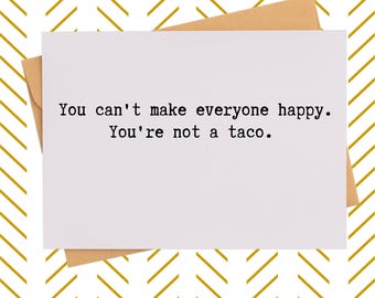 May include: A white greeting card with the text "You can't make everyone happy. You're not a taco." is placed on a brown envelope. The background features a gold and white chevron pattern.