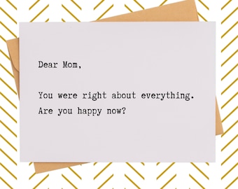 May include: A white greeting card with the text "Dear Mom, You were right about everything. Are you happy now?" is placed on a brown envelope. The background features a gold and white chevron pattern.