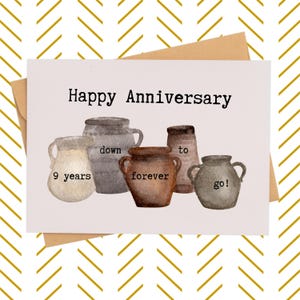 May include: A greeting card with the words "Happy Anniversary" at the top. The card features watercolor illustrations of five pottery vessels with the words "9 years down to forever go!" on the card. The card is inside a brown envelope.