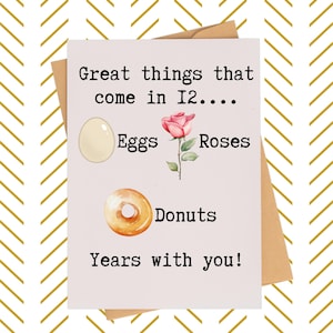 May include: Greeting card with the text "Great things that come in 12... Eggs, Roses, Donuts, Years with you!" The card features illustrations of an egg, a rose, and a donut. The card is on a brown envelope with a gold chevron pattern.