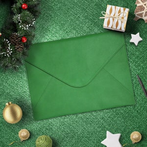 May include: A solid green envelope-style document folder with a pointed flap closure. The folder features a smooth, matte texture and clean stitched edges, presented in a flat, rectangular orientation with a simple, minimalist design.