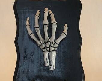 Skeleton hand plaque