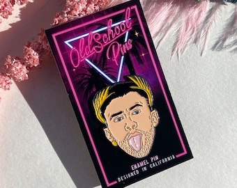 May include: An enamel pin with a neon pink border featuring a portrait of a man sticking out his tongue. The pin is black with the text "Old School Pins" and "Designed in California". Pink and blue decorative elements surround the pin.