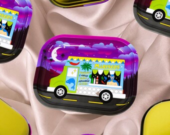 May include: Rectangular metal rolling tray with a vibrant illustration of a food truck. The truck is green and white, with the word "MARISCOS" in yellow. The background features a purple sky, a crescent moon, and palm trees.