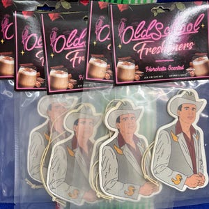 May include: Air fresheners and car accessories. The image shows several packages of "Old School Freshners" air fresheners with a horchata scent, and several car air fresheners with a cowboy design. The air fresheners are packaged in plastic.