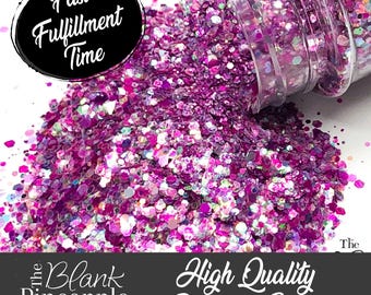 May include: A close-up of a jar of pink and iridescent glitter. The glitter is spilling out of the jar and is in a pile on a white surface. The text "High Quality Polyester Glitter" is visible at the bottom of the image.
