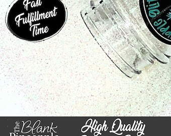 May include: A close-up of a clear jar filled with white glitter. The jar has a black label with the text "The Blank Pineapple Glitter" on it. The text "Fast Fulfillment Time" is on a black circle in the upper left corner of the image. The text "High Quality Polyester Glitter" is on a black banner at the bottom of the image.
