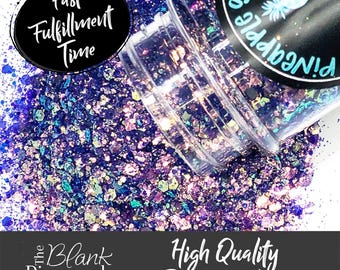 May include: A close-up of a jar of iridescent purple and blue glitter. The jar is labeled "The Blank Pineapple" and "High Quality Polyester Glitter".