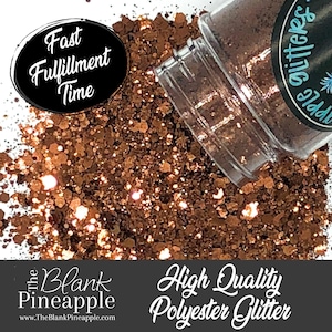 Puede incluir: Primer plano de un tarro de purpurina de cobre. La purpurina es una mezcla de piezas finas y gruesas. El tarro est&aacute; etiquetado como "The Blank Pineapple Glitter".