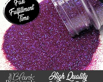 May include: A close-up of a jar of purple glitter with a holographic finish. The glitter is spilling out of the jar and the text "High Quality Polyester Glitter" is visible at the bottom of the image.