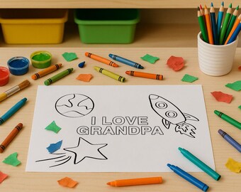 May include: A white sheet of paper with black line art featuring a planet, a rocket ship, a shooting star, and the text I LOVE GRANDPA. The paper is surrounded by scattered colourful crayons, paint pots, and paper scraps on a light wood surface.