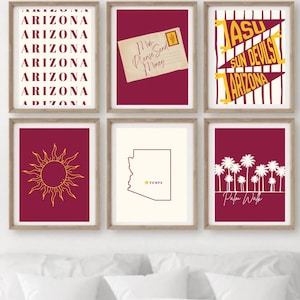 May include: Six framed art prints with a maroon and gold color scheme. The prints feature Arizona-themed designs, including the state name, a sun, a map outline with "TEMPE", and a pennant with "ASU Sun Devils Arizona". One print has a vintage postcard.
