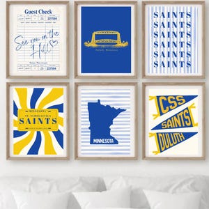 May include: Six framed art prints with a theme of Minnesota. The prints feature a guest check, a bridge, the word "SAINTS" in various designs, a license plate, a state outline, and a pennant. The color palette includes blue, yellow, and white.