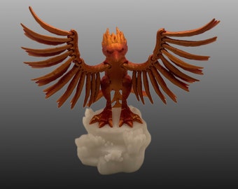 May include: A red and orange phoenix figurine with outstretched wings, standing on a white cloud base.