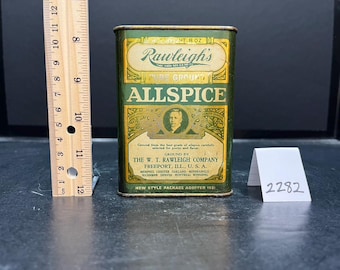 May include: Vintage Rawleigh's Allspice tin. The rectangular tin is green and gold with the text "Rawleigh's Pure Ground Allspice". The tin has a portrait of a man and text that reads "Ground by The W.T. Rawleigh Company". The tin measures approximately 4 inches tall.
