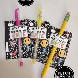 May include: Three writing supplies: a pink pen, a yellow pen, and a yellow pencil. Each is attached to a small notebook-style card with the text "LET'S START THIS YEAR OFF WRITE". The cards have a black and white composition book design.