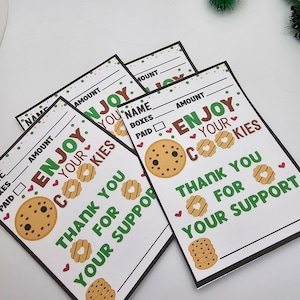 May include: Four white cards with black borders and green and red accents. Each card has a cookie graphic and the text "Enjoy your cookies" and "Thank you for your support".
