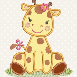 May include: A yellow and brown giraffe with a pink flower on its head is sitting on a green patch of grass. The giraffe has brown spots and a pink bow on its tail.