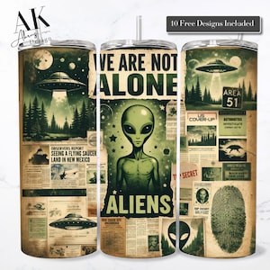 May include: A stainless steel tumbler with a retro alien theme. The design features a green alien, flying saucers, and newspaper clippings with the text "WE ARE NOT ALONE" and "ALIENS". Includes a straw and lid.