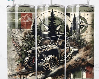 May include: A stainless steel tumbler with a wrap-around design featuring an off-road vehicle, compass, and mountain scene. The design includes the text "10 Free Designs Included" and "Seamless". The tumbler has a straw.