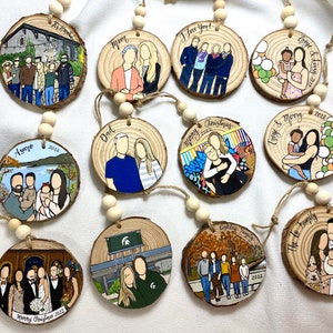 May include: A set of 10 round wooden ornaments with painted illustrations of families and the words "Mom", "Dad", "Love You!" and "Merry Christmas 2022".