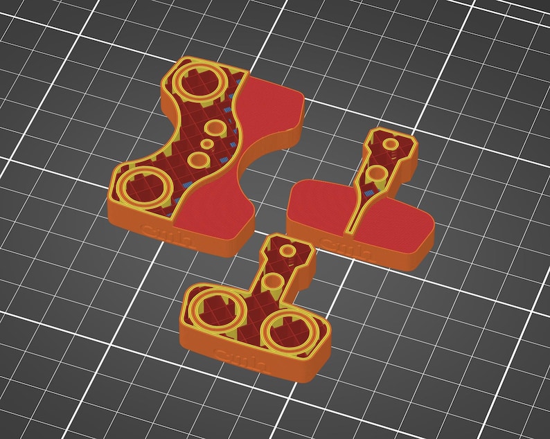 Pu&ograve; includere: Tre pezzi di puzzle rossi e arancioni con intricati disegni circolari e geometrici. I pezzi sono disposti su uno sfondo a griglia grigia, mostrando le loro forme e dettagli unici. I pezzi sembrano essere stampati in 3D.