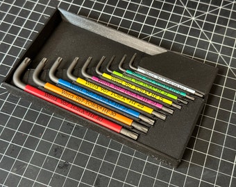 May include: A set of ten Wera 967 Torx hex keys in a black foam-lined case. The keys are color-coded with red, orange, yellow, green, blue, purple, pink, and light green labels. The labels indicate the size of each key, ranging from HF 15 to HF 40.