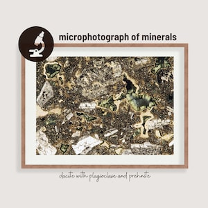 May include: Microphotograph of minerals, showing a close-up of a thin section of dacite with plagioclase and prehnite. The image shows a variety of mineral grains in different colors and textures.