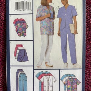 May include: A Butterick sewing pattern for professional uniform basics. The pattern features multiple views of button-down tops and pants in various colors and patterns. The pattern number is 5560, and sizes S, M, and L are available.