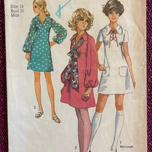 May include: Vintage Simplicity sewing pattern 8805 featuring three women's fashion designs. The pattern includes a mini-length dress, a dress with a bow, and a dress with a collared neckline. The pattern is size 14, bust 36 inches.