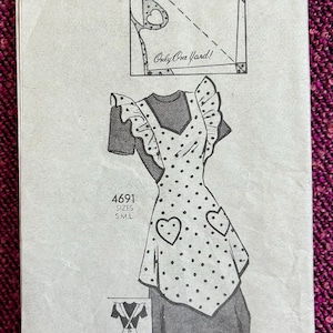 May include: Vintage sewing pattern featuring an apron design with heart-shaped pockets and polka dots. The pattern includes a diagram and the text "Only One Yard!" and "4691 S.M.L." on a white paper background.