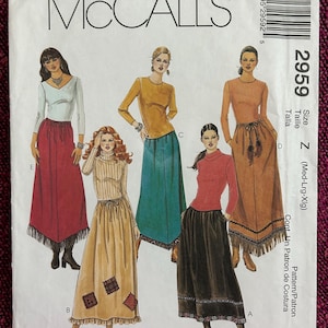 May include: McCall's sewing pattern for a long skirt with fringe. The pattern is for sizes Medium, Large, and Extra Large. The pattern includes instructions for making the skirt with different fabric options.