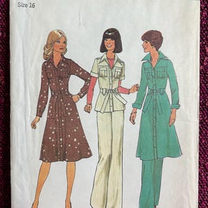 May include: Vintage Simplicity sewing pattern number 7649, size 16, featuring three different dress designs. The first dress is brown with white stars, the second is a white shirt and pants set, and the third is a green dress with a matching pants set.
