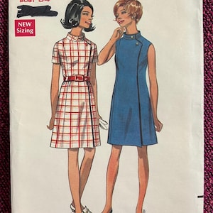 May include: Vintage Butterick sewing pattern 5172 featuring two dress designs. One dress is a sleeveless blue shift, and the other is a short-sleeved dress with a red and white plaid pattern. The pattern includes sizes 8-16, with a bust size of 34 inches.