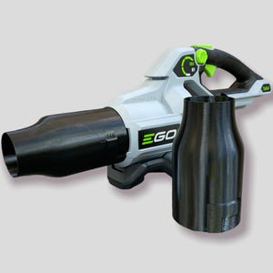 May include: A cordless leaf blower with a black nozzle and a separate black attachment. The blower is white and gray with green accents and the brand name "EGO" in green. The blower has a black handle.