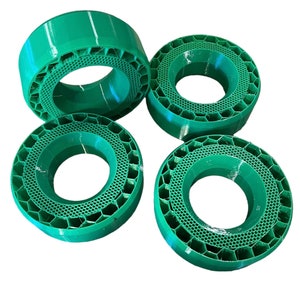May include: Four green plastic rings with a honeycomb pattern. The rings are stacked on top of each other.