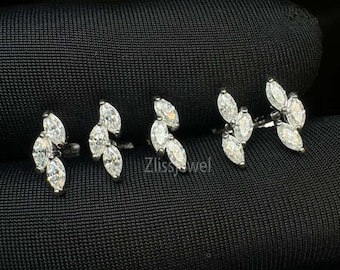 Pendiente de plata 925 con forma de llama y diamantes dispersos en forma de marquesa para hélice y cartílago. Piercing para labio y labio con parte trasera plana.