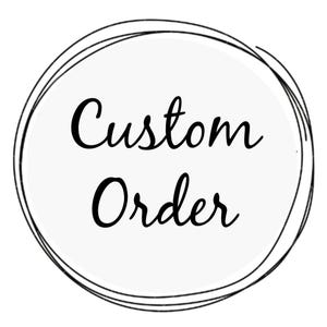 May include: A white circle with the words "Custom Order" in black script lettering. The circle is outlined with a series of black, hand-drawn lines, creating a frame around the text.
