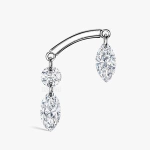May include: A silver curved barbell with two dangling marquise-shaped clear gemstones and a round clear gemstone.
