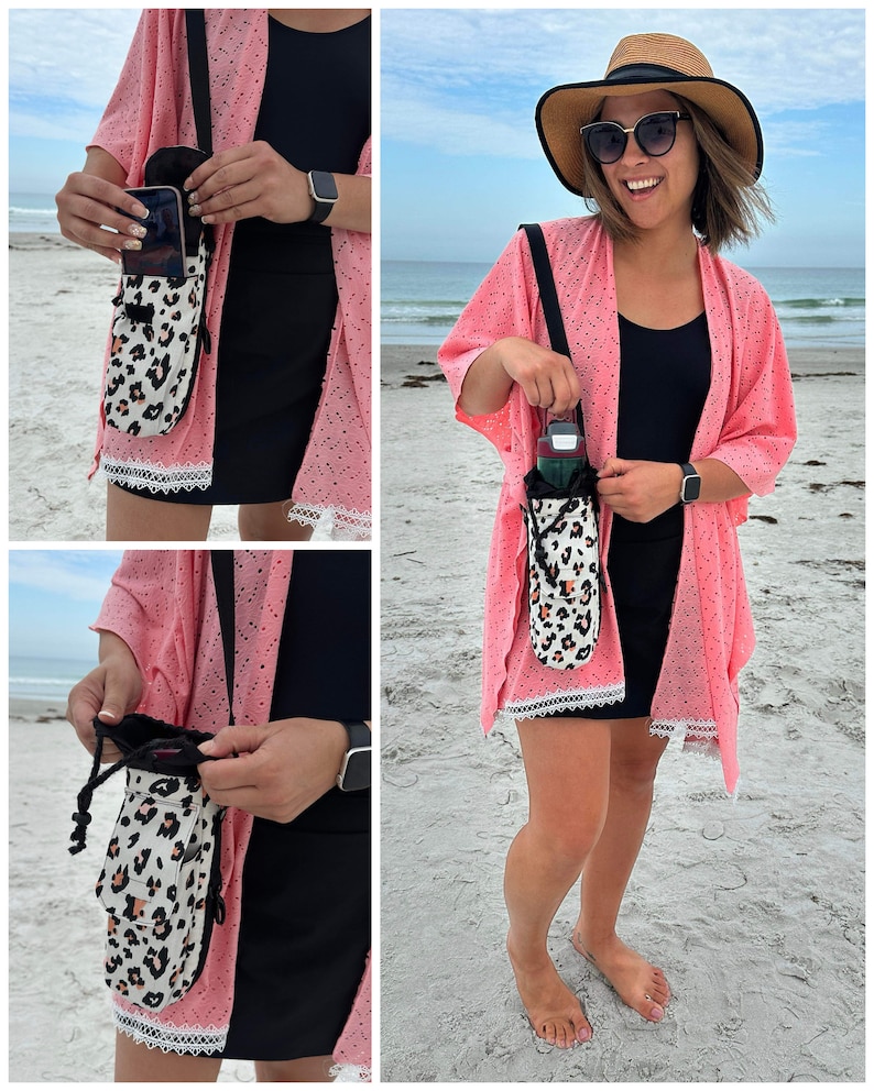 May include: A crossbody bag with a black strap and a white and tan leopard print pouch. The pouch has a drawstring closure and a pocket. The bag is being held by a person on a beach.