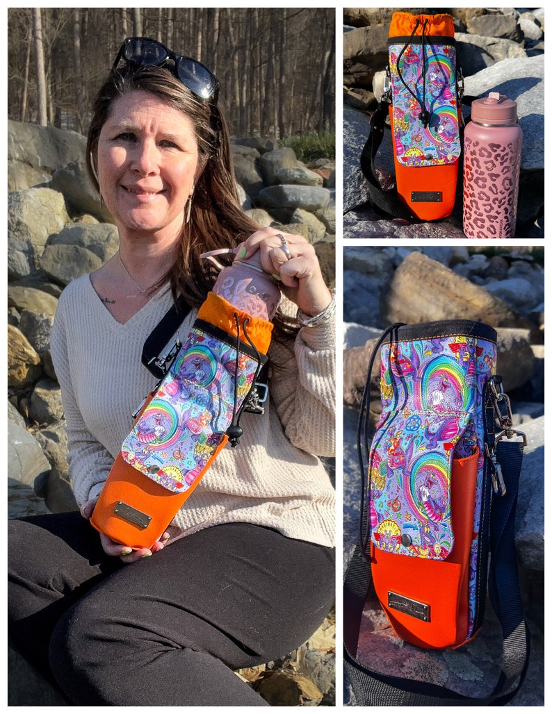 May include: A water bottle carrier with a colorful, whimsical design featuring unicorns, rainbows, and psychedelic patterns. The carrier has an orange base and a black adjustable strap. A matching water bottle with a pink leopard print is also visible.